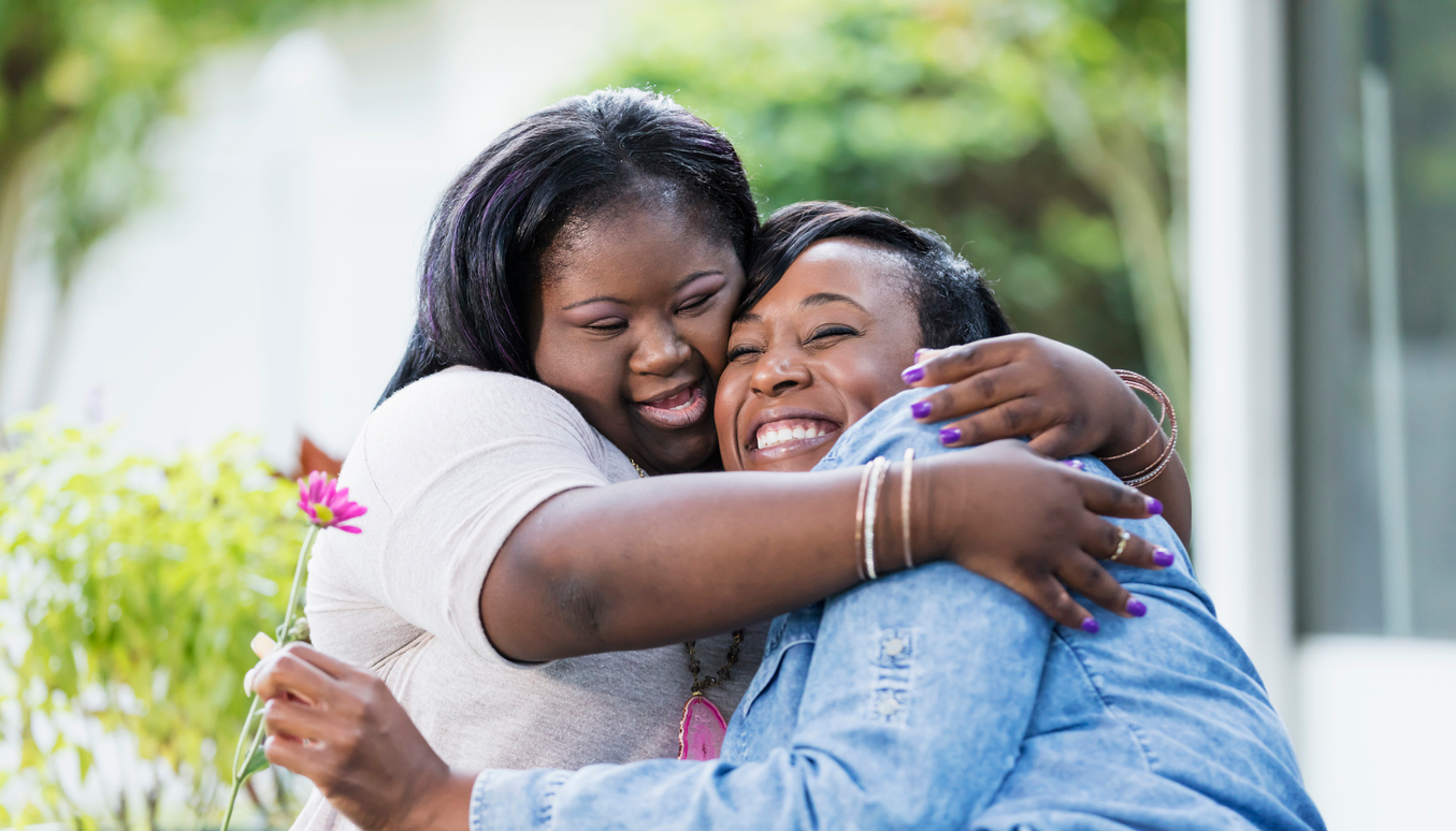 Young Adult with IDD hugging Mom