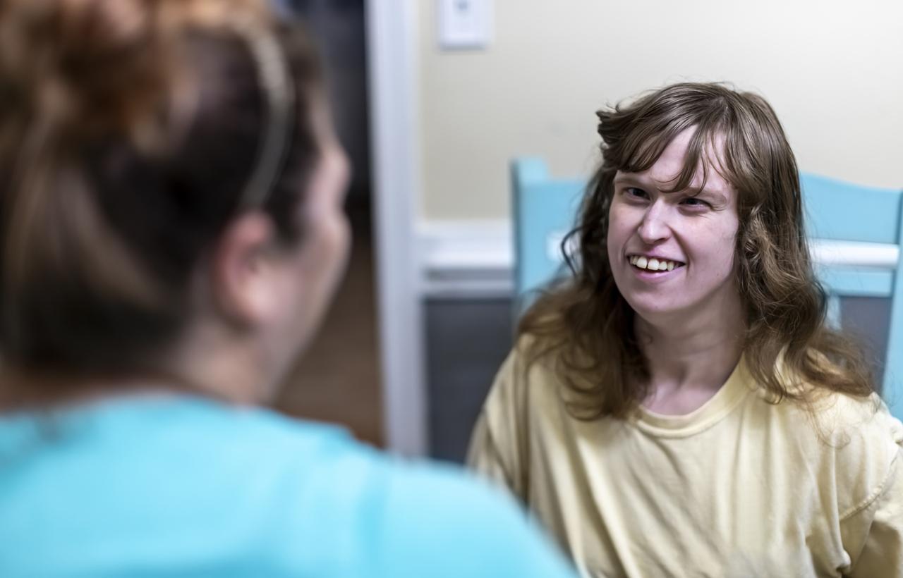 Caregiver brings a smile to intellectually disabled woman's face