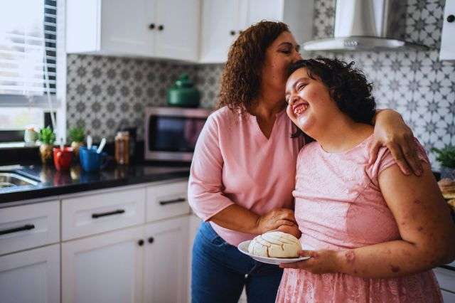 Mom hugging daughter in the kitchen