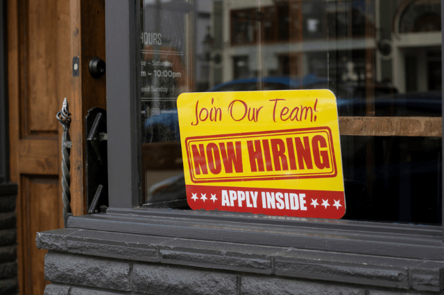 Shortages Now Hiring Sign in Store window