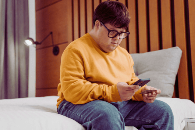 Man with Down Syndrome looking at phone