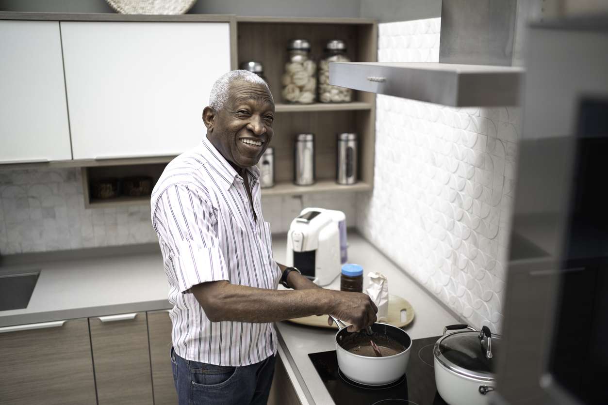 Man at kitchen stove cooking