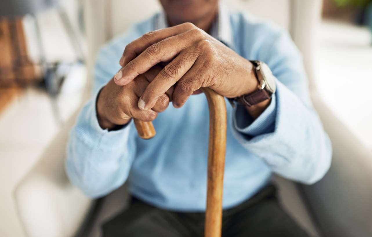 Man holding a cane